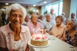 © CojanAI - Portrait of smiling diverse seniors celebrating birthday in nursing home