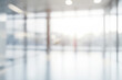 © sergign - A blurred view of an empty modern office space with large windows and a bright ambiance extending serenity and cleanliness.