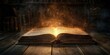 © jambulart - An open book glowing with magic on a wooden table.