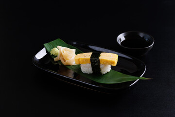 Wall Mural - Tamago sushi egg sushi Japanese food Japanese seafood isolated in black background