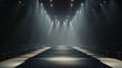 © hugy - A dark stage with an extended runway illuminated by spotlights, prepared for a performance or fashion show
