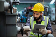 © eakgrungenerd - Man technician worker using tablet control setting up checking operating machinery of lathe metal factory industrial. Male worker wear yellow hardhat controlling at industrial workshop.