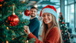 © Favio - 20s Caucasian young woman decorating a christmas tree in an office with her co-worker. Workplace Holiday Cheer.