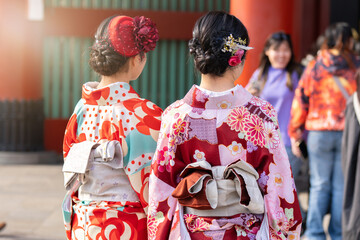 Young girl wearing Japanese kimono standing in front of Sensoji Temple in Tokyo, Japan. Kimono is a Japanese traditional garment. The word 