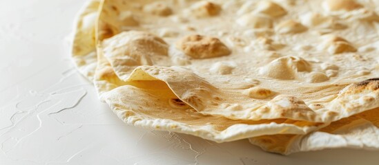 Wall Mural - Thin pita bread against a white background Close up of Armenian pita bread. Copy space image. Place for adding text and design