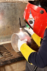 worker welding in factory, workshop