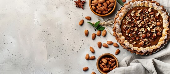 Poster - Tasty tart featuring caramel almonds and hazelnuts on a light colored concrete backdrop Top view flat lay natural color grading. Copy space image. Place for adding text and design