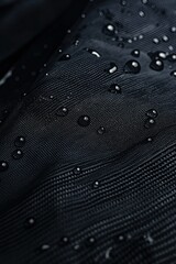 Aufkleber - Black fabric displays water droplets beading up, water-repellent properties. High-resolution studio features intricate details of synthetic material texture, uniform droplet distribution.