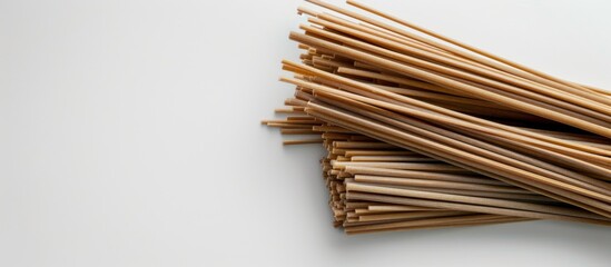 Canvas Print - a small amount of dry buckwheat noodles on a white background copyspace