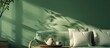 © Ilgun - Tray with a teapot on a designer sofa beside a green wall. Copy space image. Place for adding text and design
