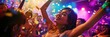 © miss irine - Asian woman dances joyfully on nightclub dance floor surrounded by group of young people dancing and having fun. Colorful lights, vibrant atmosphere, confetti create lively party scene.