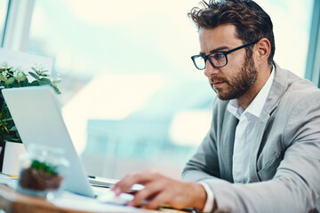 Business, man and research on laptop in office for startup management, planning or reviewing company proposal. Professional, employee or technology for online report, website update or administration