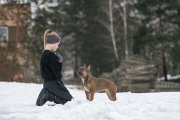 Wall Mural - Portrait of a beautiful ten year old girl with a dog.