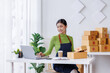 © David - Small business entrepreneur SME freelance asian woman working at home, check online, marketing, packaging, delivery, sell to customers, sme e-commerce concept.
