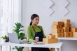 © David - Small business entrepreneur SME freelance asian woman working at home, check online, marketing, packaging, delivery, sell to customers, sme e-commerce concept.