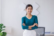 © David - Portrait of young Asain business woman standing with confidence expression arms crossed and looking at the camera in the office.