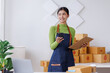 © David - Startup SME small business entrepreneur SME or freelance Asian woman calling phone, online marketing packaging box and delivery, SME concept