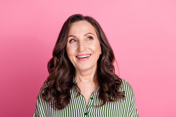 Poster - Portrait of pretty aged woman look empty space wear striped shirt isolated on pink color background