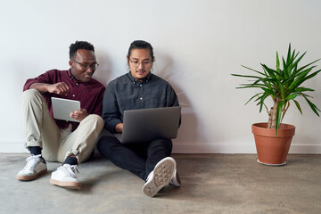 Poster - Floor, laptop and tablet of business people in office, planning and research for startup in creative agency. Workplace, men or web developer with technology for layout design, solution and teamwork