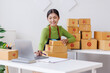 © David - SME business asian entrepreneurs small in Asia Write shipping information on a cardboard box in home office. Small business sme operators preparing to ship to customer