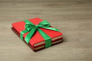 Wall Mural - Books with ribbon as gift on wooden table