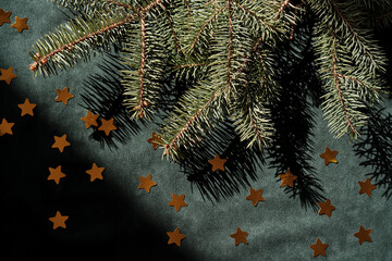 Wall Mural - abstract green velvet christmas background with christmas tree branches and gold stars.