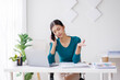 © David - Cheerful business Asian woman freelancer making telephone call share good news about project working in office workplace, business finance concept.