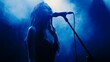 © Edifi 4 - Woman singing on stage under dramatic blue lighting