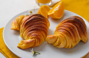 Wall Mural - Brioche croissants on a plate with oranges