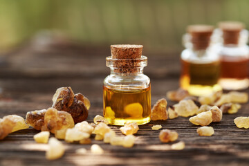 Wall Mural - A bottle of frankincense essential oil with boswellia resin on a table