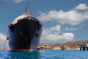 Wall Mural - Malta, the area around the fishing village of Marsaxlokk, in the foreground the Mediterrana Armada LNG ship moored at the gas pier during gas loading