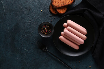 Wall Mural - Plate with tasty thin sausages and peppercorn on dark background