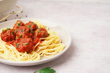 Wall Mural - Plate of boiled pasta with tomato sauce and meat balls on white table