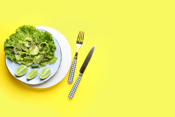 Canvas Print - Plate of tasty vegetable salad on yellow background