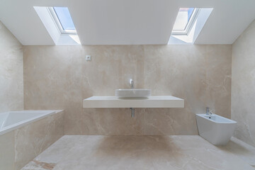 Interior photo of modern stylish bathroom with 2 roof windows in beige colors