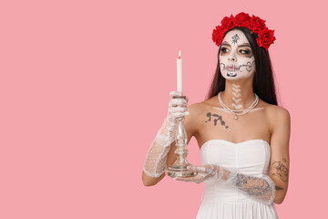 Poster - Young woman dressed as dead bride for Halloween party holding candlestick with candle on pink background