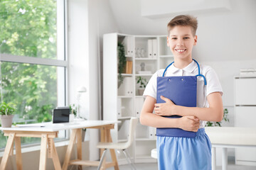 Canvas Print - Teenage doctor with clipboard in clinic