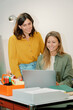 © Franci Leoncio - Two women collaborating on a business project in a bright office space