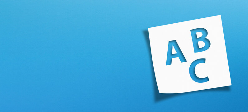 White note paper with Letters ABC on blue background