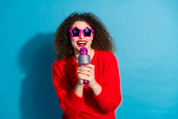 Photo portrait of lovely young lady sing karaoke discotheque dressed stylish red garment isolated on blue color background