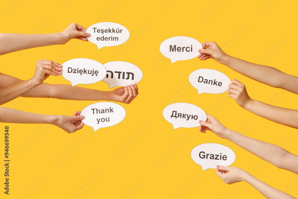 Female hands holding speech bubbles with text THANK YOU in different languages on yellow background