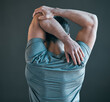 © Haas/peopleimages.com - Stretching arms, fitness and back of man for exercise, training and warm up for workout on gray background. Health, sports and person with strength for wellness, performance and flexibility in gym