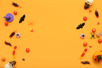 Wall Mural - Composition with sweet candies and decorations for Halloween on orange background