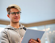 © Andreas Prott - Male intern, student, apprentice holding a tablet in a modern office