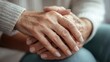 © Naknakhone - Closeup of a support hands. Closeup shot of a young woman holding a senior man's hands in comfort. Female carer holding hands of senior man.