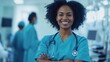 © Naknakhone - Portrait and surgeon with black woman, arms crossed and confidence of medical doctor job. Hospital, smile and healthcare professional with stethoscope and cardiology clinic employee at work.