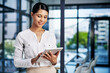 © ReeseBuyout3/peopleimages.com - Smile, woman and personal assistant on tablet for business, email reply and online networking. Receptionist, application or secretary on technology for research, agenda planning and meeting schedule