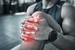 © peopleimages.com - Fitness, person and hands for knee pain on gym floor of wrong workout technique, injury recovery exercise and tendinitis. Man, red glow and muscle ache of strain on leg, training and osteoporosis.