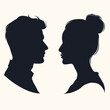 © umut hasanoglu - Silhouettes of a man and woman facing each other on a light background.