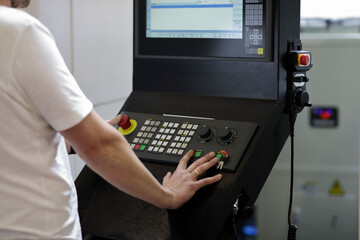 operator controls industrial CNC machining center